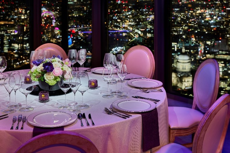 Elegant dining table with city view for upscale events and corporate dinners. - Banner