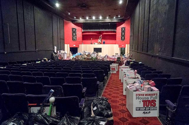 Cluttered event venue in The Miracle Theater post-event, highlighting cleanup logistics.