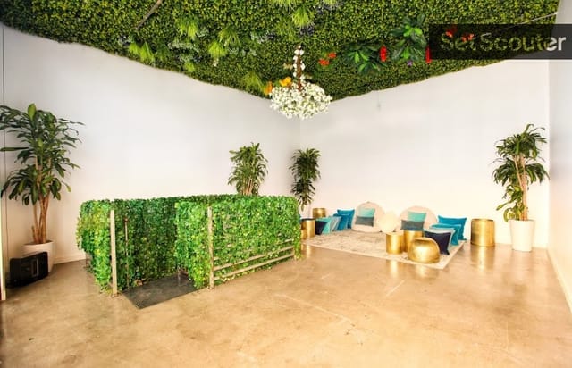 Versatile event space with lush green ceiling, perfect for meetings and gatherings.