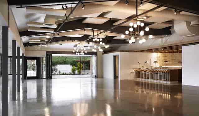 Modern event space with polished concrete floors, ideal for corporate events and gatherings.