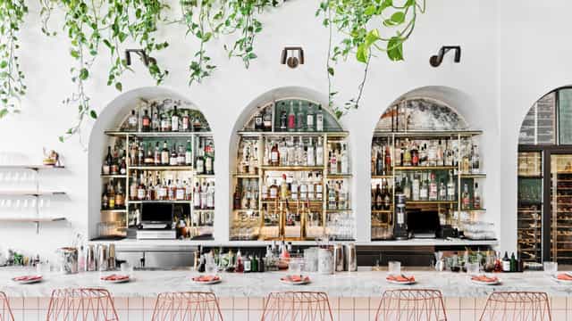 Stylish Bavel Restaurant bar with arched shelves, ideal for cocktail receptions and networking.