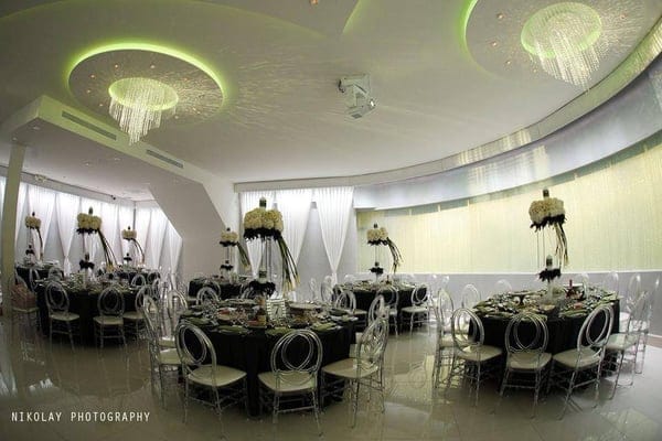 Elegant Pure Banquet Hall foyer with round tables, ideal for weddings and corporate events.