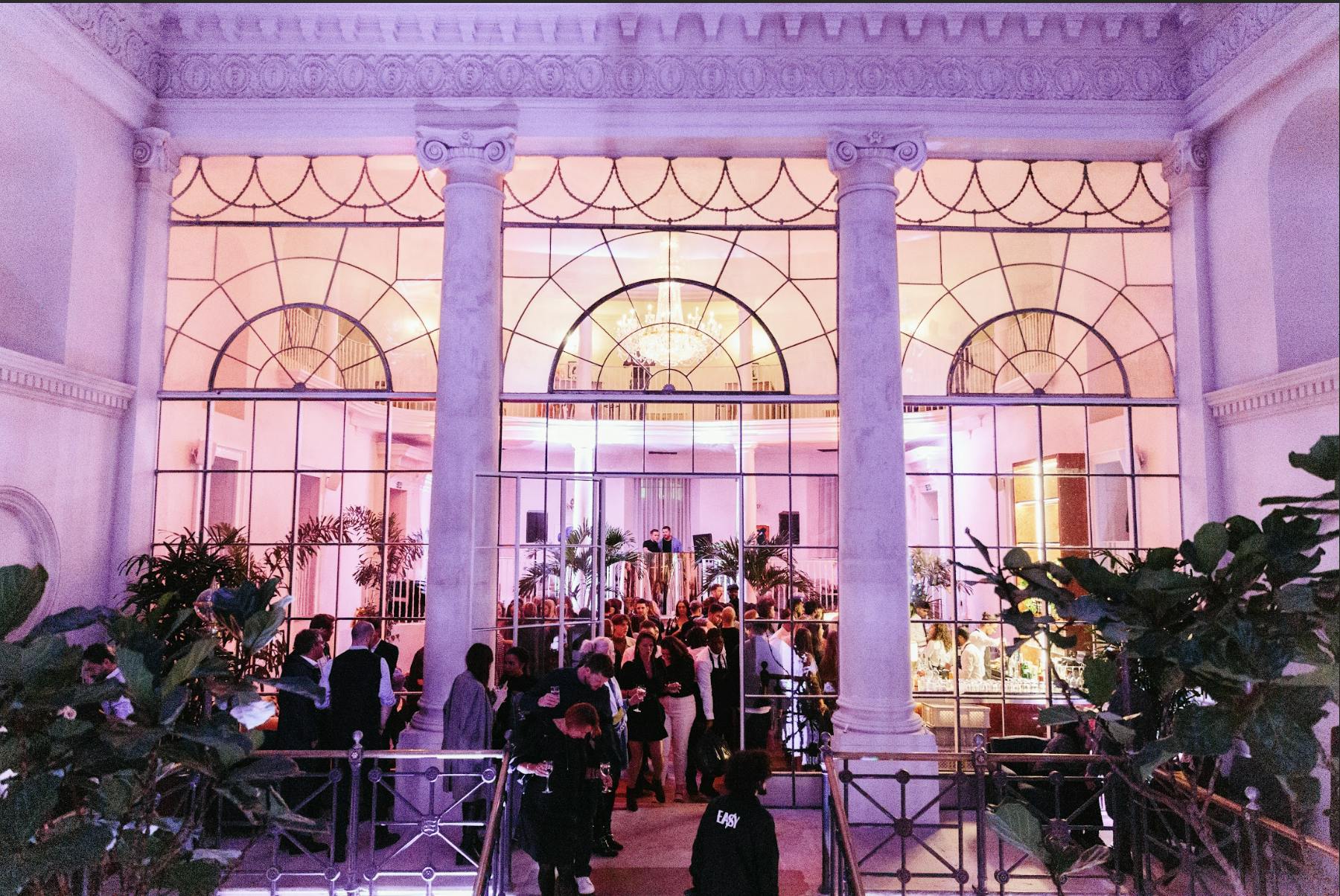 Full House Takeover at Knotel Workclub, elegant venue with pink lighting for networking events.