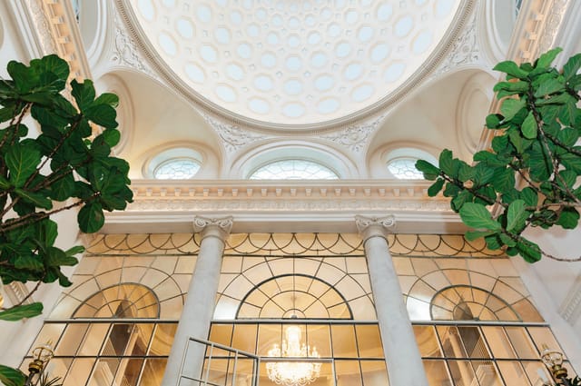 Elegant venue with grand ceiling, ideal for upscale corporate events and receptions.