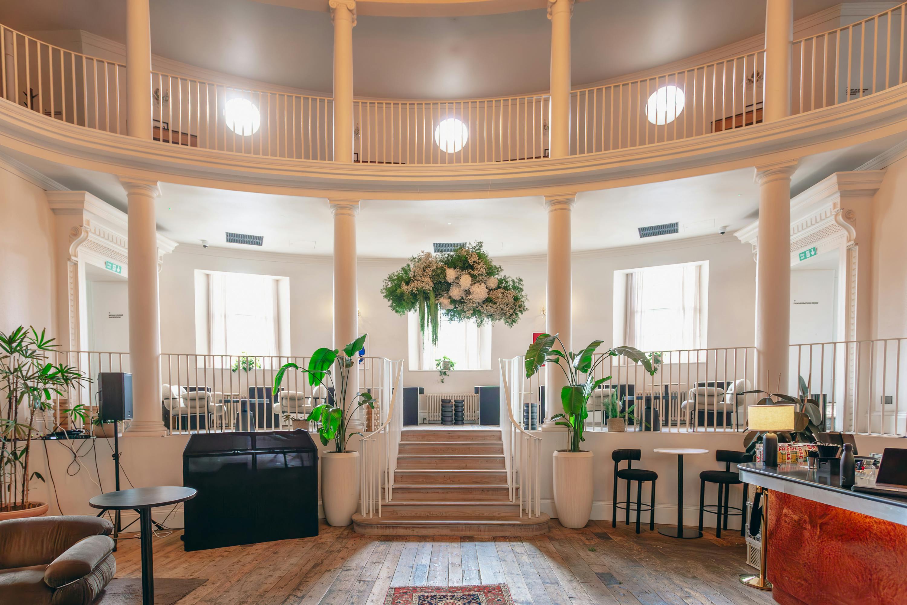 Elegant wedding venue with circular layout, natural light, ideal for corporate events.