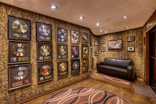Main Stage at Tiny Room Studios with gold records, perfect for networking events.