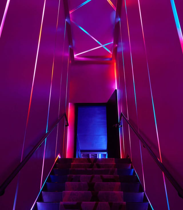 VIP Mezzanine staircase at The Vermont Hollywood, vibrant lighting for events and gatherings.