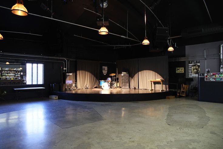 Zebulon Cafe Concert stage with industrial decor, perfect for live performances and events.