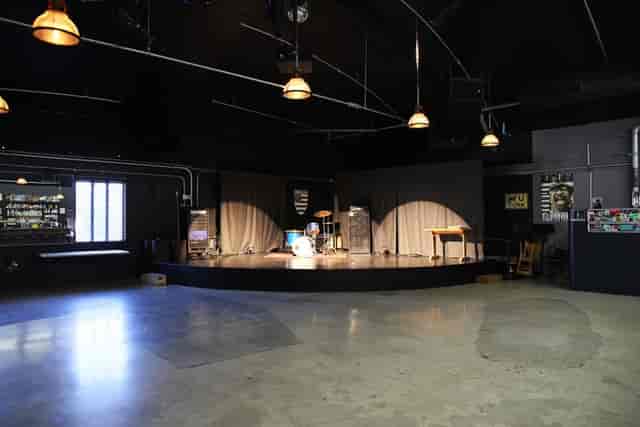 Zebulon Cafe Concert stage with industrial decor, perfect for live performances and events.