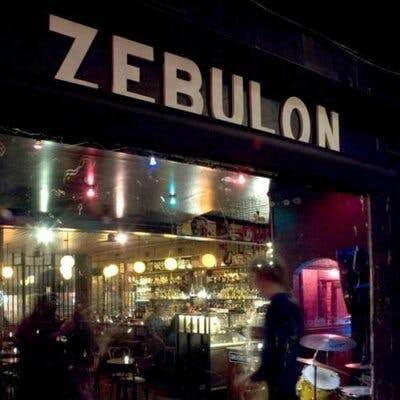 Zebulon Cafe Concert: vibrant venue with illuminated bar for intimate gatherings and events.