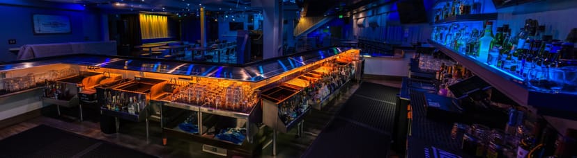 Modern bar area with extensive spirits selection, perfect for networking events and gatherings.