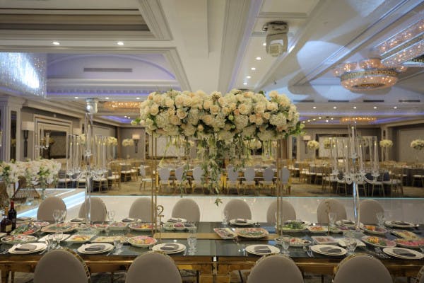 Elegant Glenoaks Ballroom with floral centerpiece, perfect for weddings and corporate events.