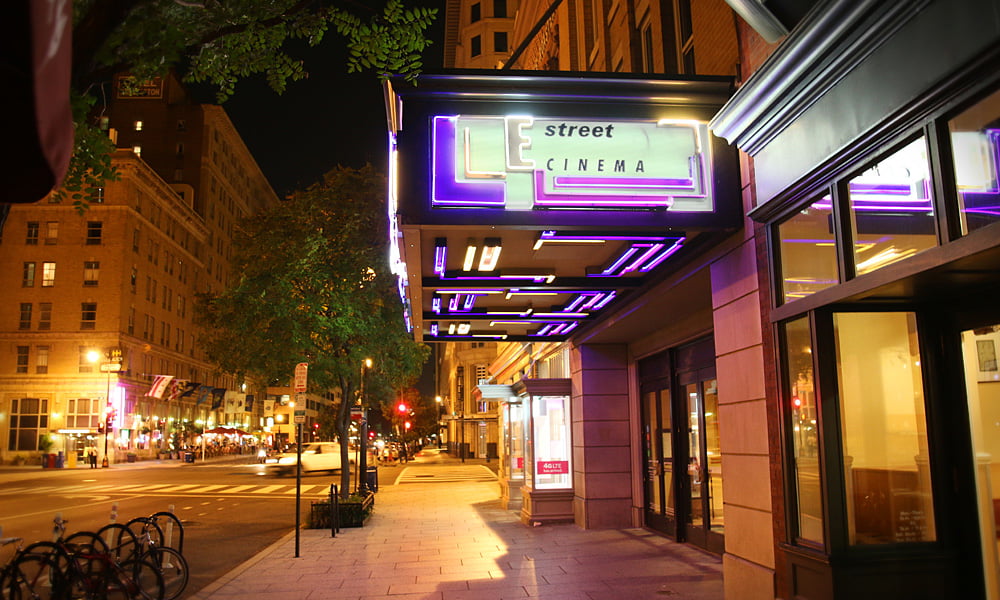 Ovation Hall at night, vibrant neon lights for film screenings and events.