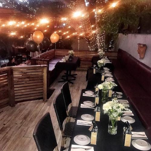 Elegant event space at Pip's on La Brea with floral centerpieces for intimate gatherings.