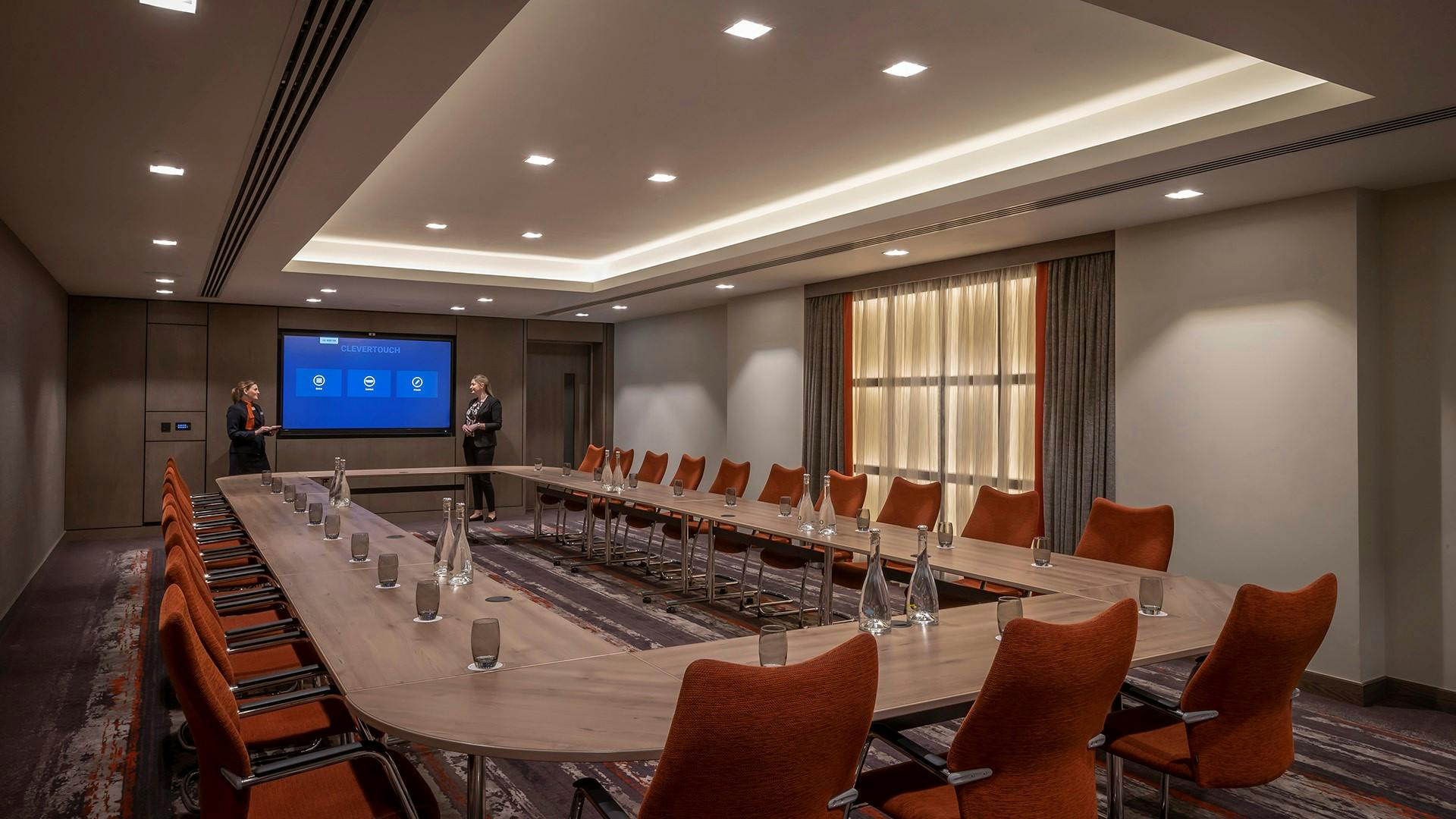 Modern meeting room in Clayton Hotel Dublin with large table, ideal for workshops and conferences.
