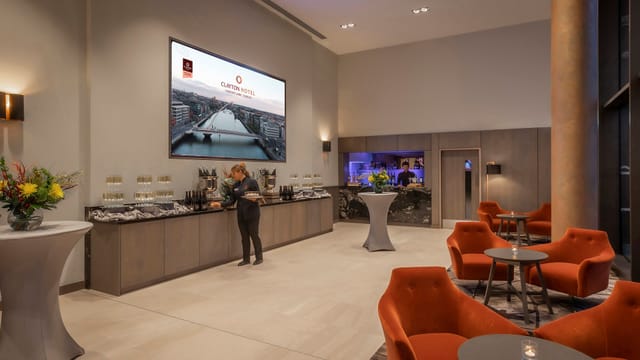 Modern event space at Clayton Hotel Dublin with digital display and elegant seating.