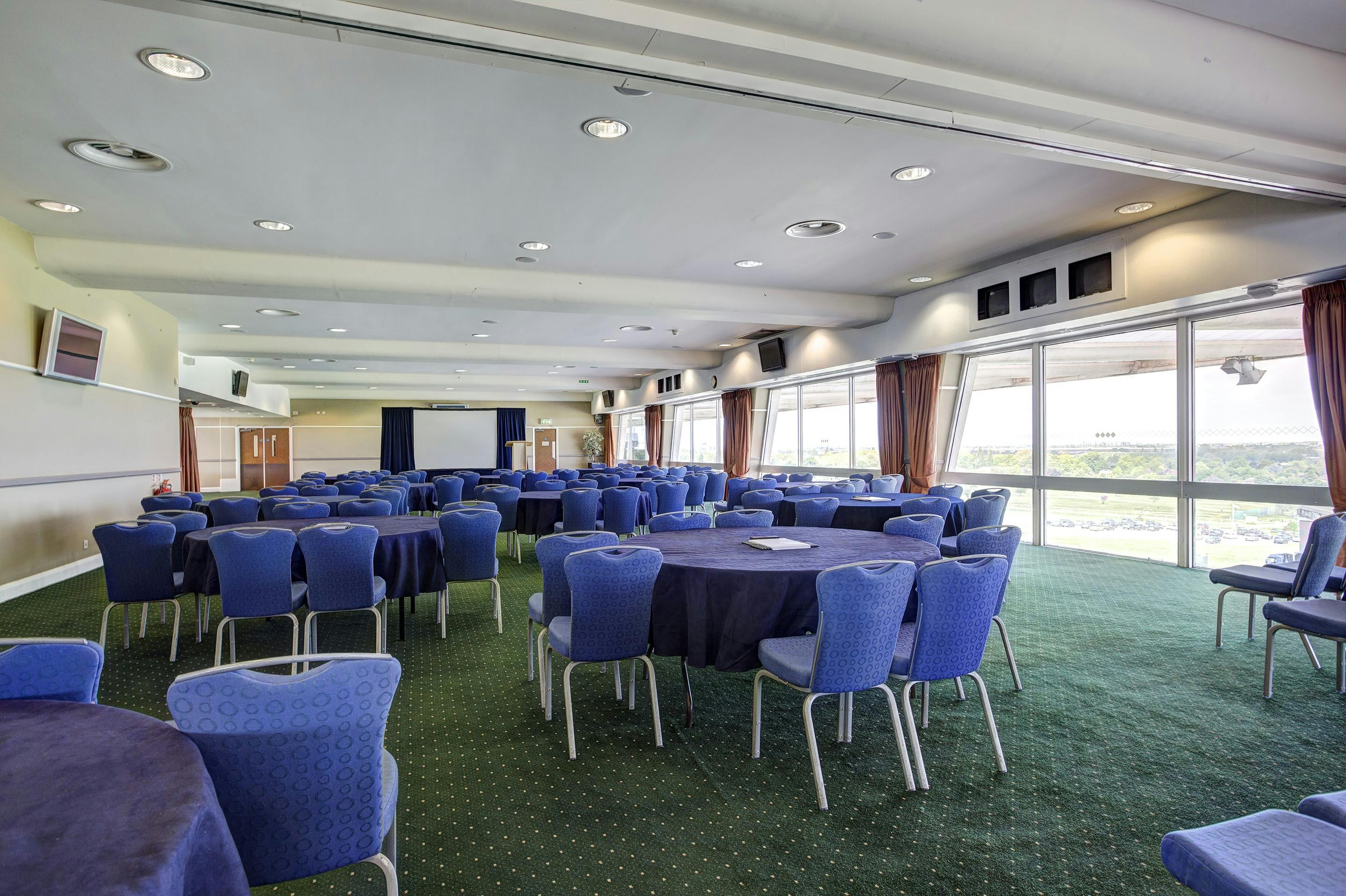 Gold Cup Suite at Sandown Park: spacious venue with round tables for meetings and banquets.