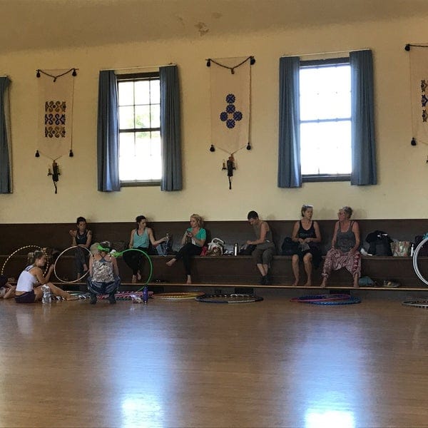 Hula hoop workshop in a bright, spacious Finnish Hall auditorium for community events.