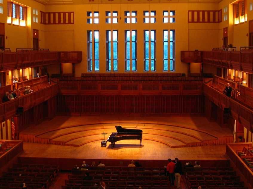 Elegant concert hall with grand piano, ideal for performances and events.