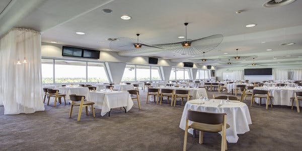 Elegant event venue at Sandown Park Racecourse with round tables for corporate gatherings.