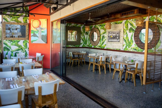 Vibrant dining space at The Zon, featuring lush greenery for events and meetings.