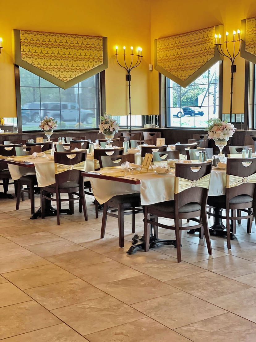 Elegant banquet hall setup with floral centerpieces for weddings and corporate events.