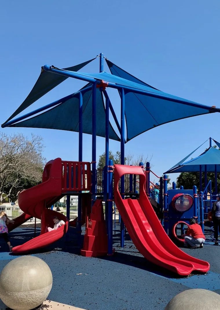 Vibrant playground with colorful slides for family-friendly community events.