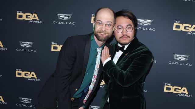 "Directors Guild Awards: Two individuals in formal attire at a glamorous ceremony."