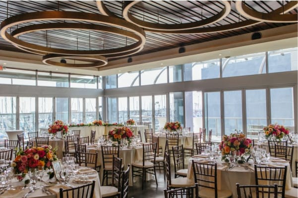 Elegant banquet hall with floral centerpieces, perfect for weddings and corporate events.