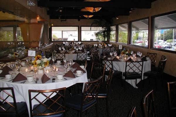 Elegant event space with round tables, ideal for corporate gatherings at Redondo Beach.