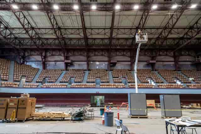 Large open venue at Henry J. Kaiser Center, event setup with seating and construction materials.
