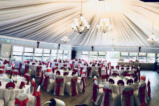 Elegant banquet hall with round tables, ideal for weddings and corporate events.