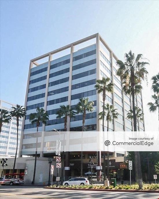 Modern office building with palm trees, ideal for corporate meetings and events.