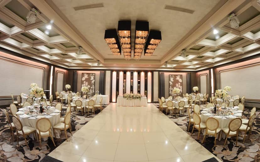 Elegant Crystal Ballroom with floral centerpieces, perfect for weddings and corporate events.