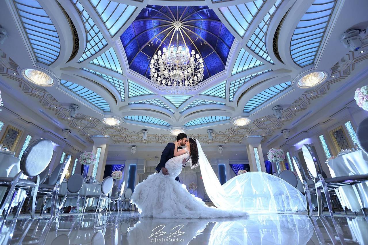 Elegant wedding venue at Bella Blanca Events with grand chandelier and romantic couple.