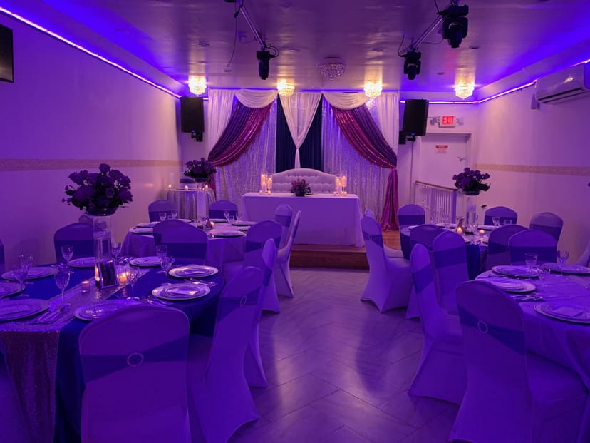 Elegant banquet hall with purple lighting, perfect for weddings and corporate events.