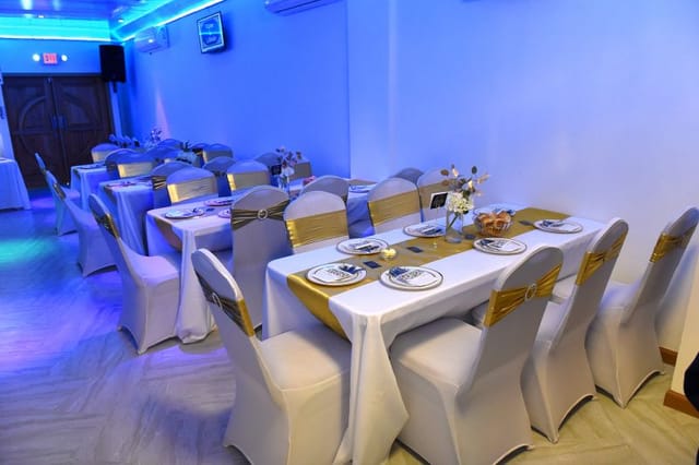 Elegant banquet hall with blue lighting, perfect for formal events and celebrations.