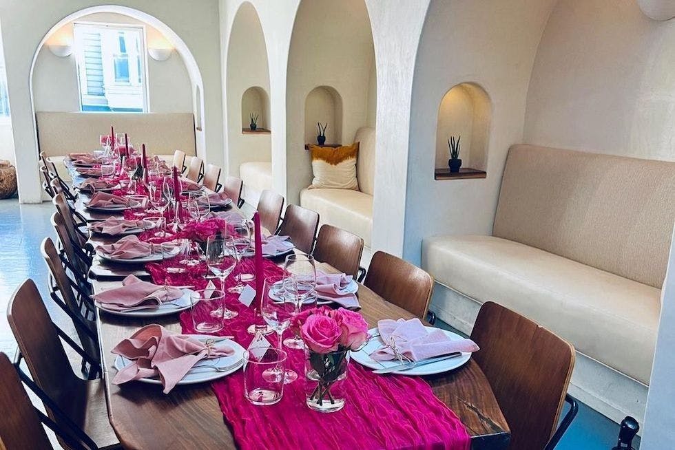 Elegant dining setup with pink linens for private dinners and intimate events.