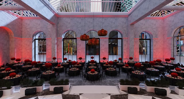 Elegant event space with round tables and red floral centerpieces at One Sansome.