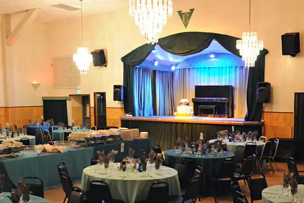 Elegant banquet hall with blue tablecloths, ideal for events and conferences.