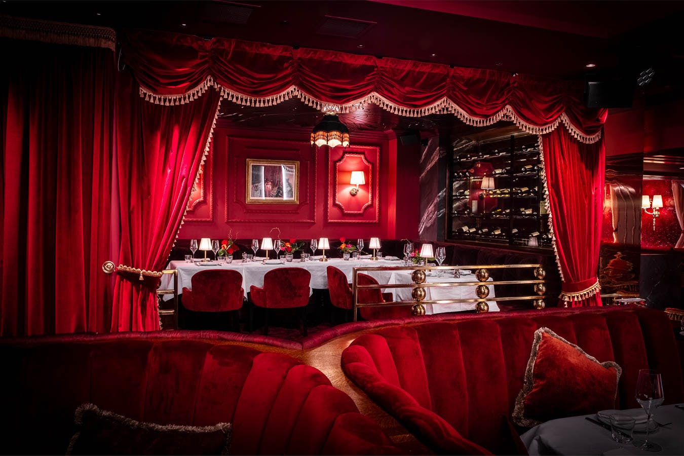 Private dining room at Mistress of Mayfair with rich red decor, ideal for upscale events.
