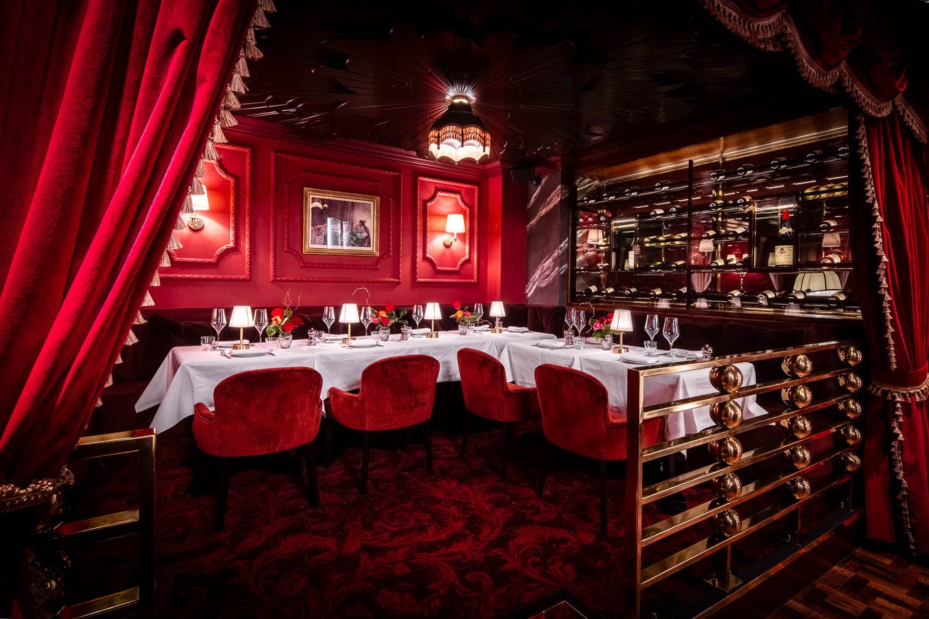 Elegant private dining room with rich red decor for upscale events and gatherings.