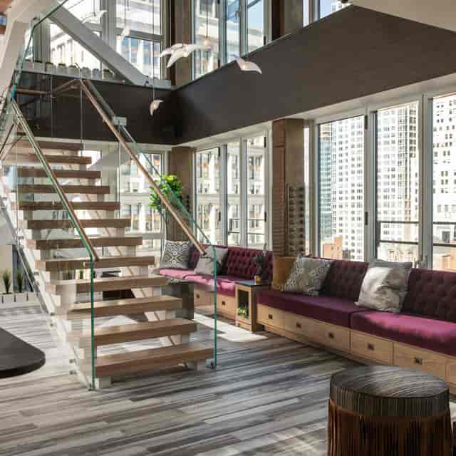 Modern event space at Hide Rooftop with city views and stylish staircase for networking.
