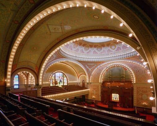 Ornate chapel venue with tiered seating for conferences and gala dinners.
