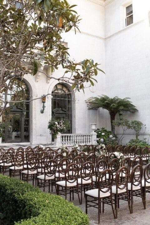 Elegant Flood Mansion outdoor event space for weddings with lush greenery and floral decor.