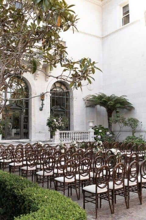 Elegant Flood Mansion outdoor event space for weddings with lush greenery and floral decor.