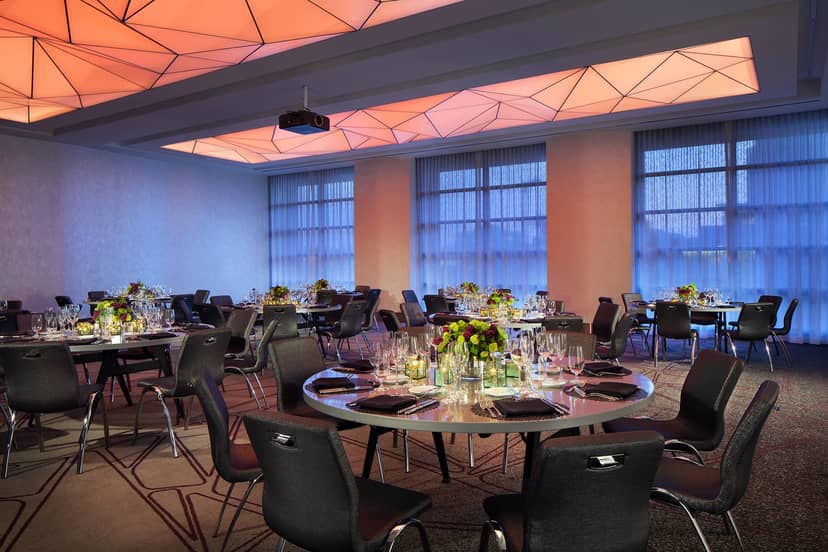 Private Hall & Banquet Room with elegant tables for corporate events and upscale gatherings.