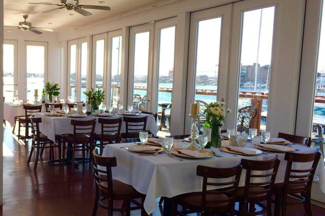 Elegant banquet hall with waterfront view, ideal for weddings and corporate events.
