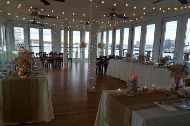 Elegant banquet hall with waterfront view, ideal for weddings and upscale receptions.