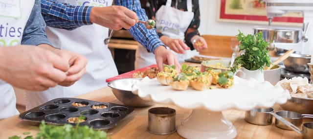 Hands-on culinary event at Chef's Table, showcasing teamwork and creativity in cooking.